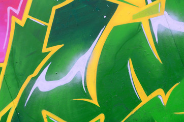 Fragment of graffiti drawings. The old wall decorated with paint stains in the style of street art...