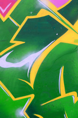 Fragment of graffiti drawings. The old wall decorated with paint stains in the style of street art...