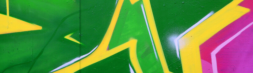 Fragment of graffiti drawings. The old wall decorated with paint stains in the style of street art...