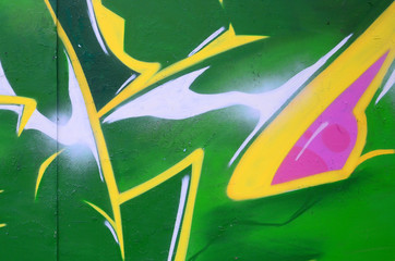 Fragment of graffiti drawings. The old wall decorated with paint stains in the style of street art...