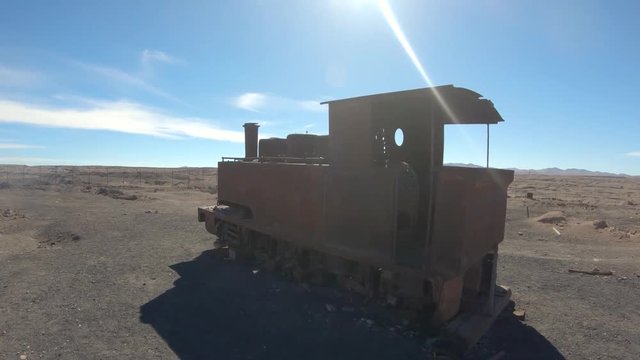 Abandoned Humberstone and Santa Laura saltpeter works factory, near Iquique, northern Chile, South America. Walking outside around old rusty train wagon.