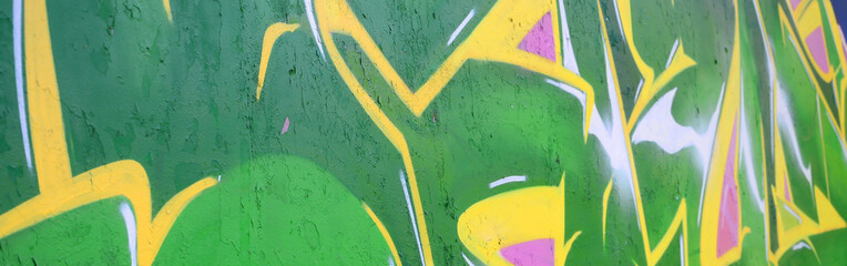 Fragment of graffiti drawings. The old wall decorated with paint stains in the style of street art...