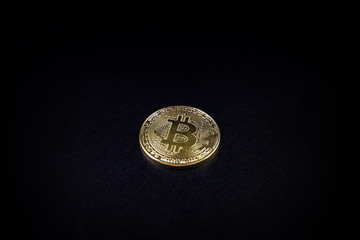 Gold coin bitcoin isolated on black background with reflection