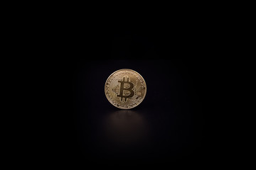 Gold coin bitcoin isolated on black background with reflection