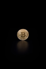 Gold coin bitcoin isolated on black background with reflection