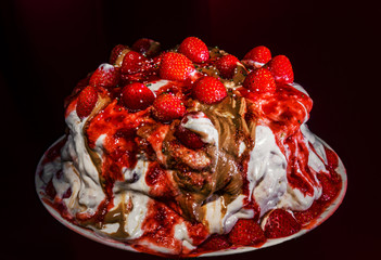 Homemade strawberry cake isolated on dark background