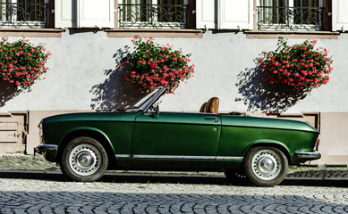 Beautiful retro green car on the street, sunny day