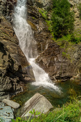 Fototapeta na wymiar waterfall in the mountains among the rocks