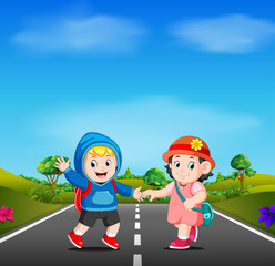 two kids go to school on the road