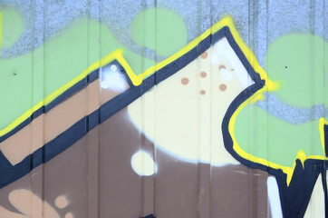 Fragment of graffiti drawings. The old wall decorated with paint stains in the style of street art...