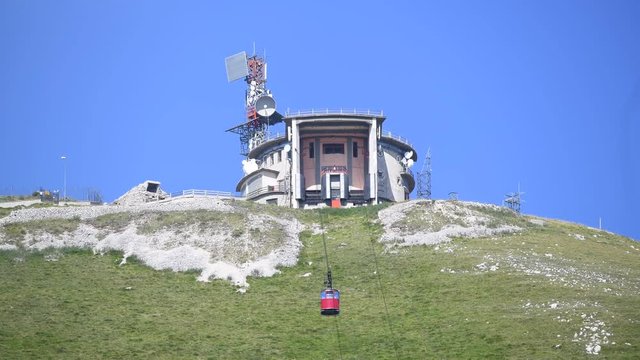 Mountain top and cable car climbing arrival to station