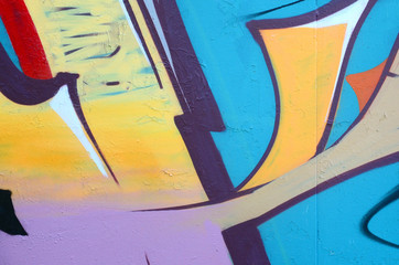 Fragment of graffiti drawings. The old wall decorated with paint stains in the style of street art...