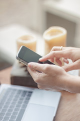 Woman using smart phone in coffee shop