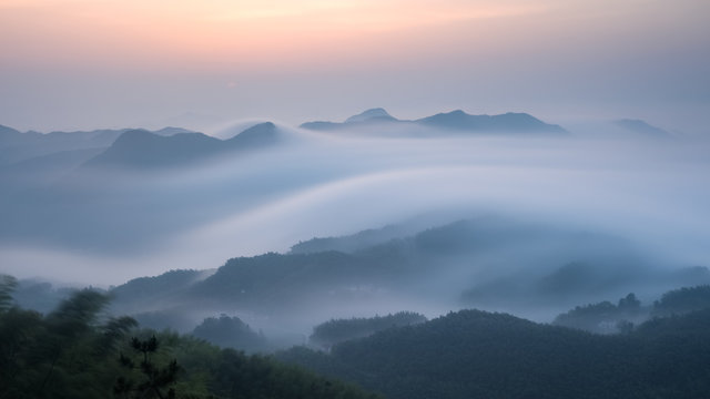 Fototapeta sea of clouds over the mountains at dawn