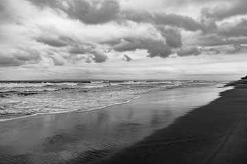 Black sand volcano beach on the ocean / sea coast.