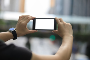 Hands hold smartphone take pictures in modern city