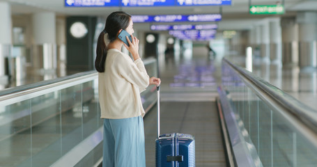 Fototapeta premium Woman talk to cellphone in airport