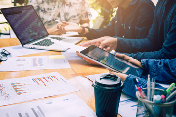 Asian colleagues using tablet and analysis about financial result working together.