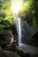 Serenity and yoga practicing at waterfall