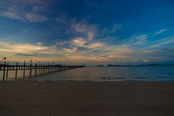 Fototapeta premium Wooden bridge on sea beach sunrise colorful sky
