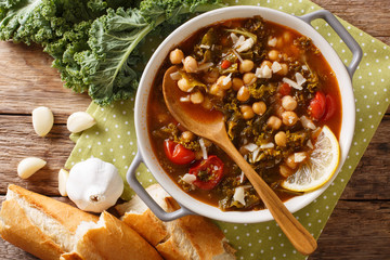 Stewed kale cabbage with chickpeas and vegetables close-up. Horizontal top view