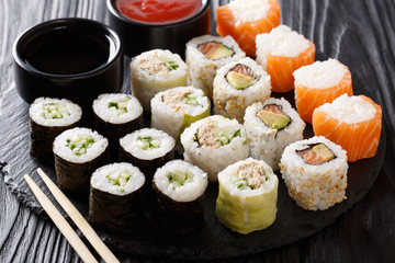 Japanese food: a menu of rolls with seafood close-up with sauces. horizontal