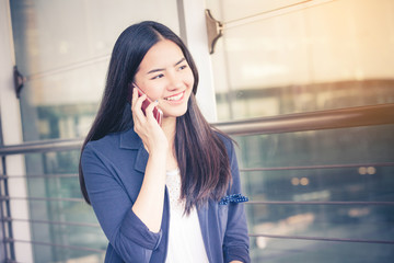 Airport woman on smart phone at gate waiting in terminal. Air travel concept.