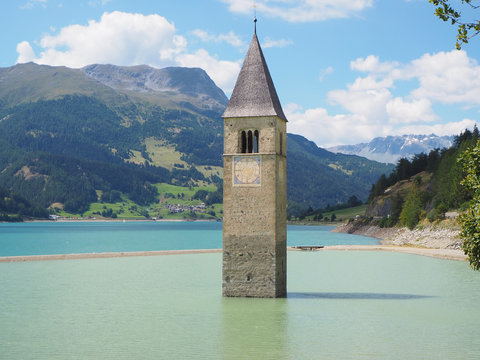 Curon, Italy. View of the old bell tower of the village rising out of the waters lake of Resia