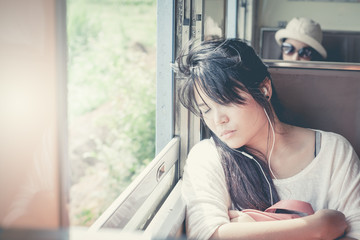 Asian woman listening to music and enjoy.