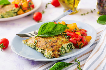 Frittata with zucchini, cheese, basil and salsa from tomatoes. Useful breakfast. Italian omelette.