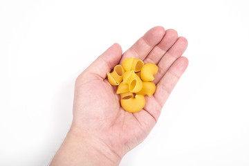 Pipe rigate pasta in a hand, isolated on a white background