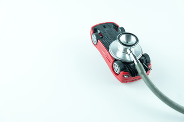 Stethoscope checking up the car on white background, Concept of car check up, repair and maintenance..
