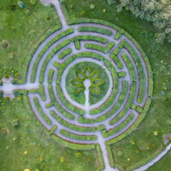 Aerial view of a natural labyrinth round shape in the garden. Photo from the drone.