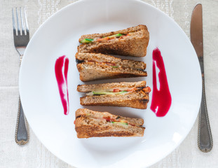 Sandwiches of triangular shape. With cheese, cucumbers, basil and tomatoes.