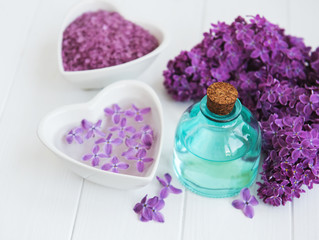 Essential oil and sea salt with lilac flowers