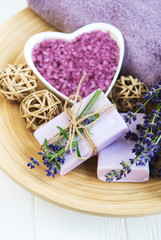 Heart-shaped bowl with sea salt, soap and fresh lavender flowers