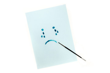 Blue, sad face with tears, hand painted on blue paper in watercolor, depression concept, with copyspace