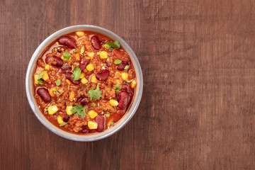 Chili con carne, traditional Mexican dish, overhead photo with copyspace
