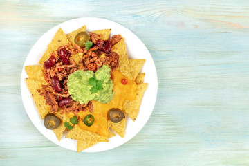 Nachos with cheese and chilli, traditional Mexican snack, with copyspace