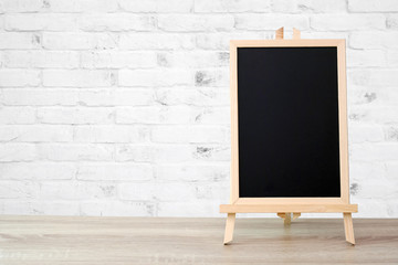 Blank vintage wood chalkboard on brick wall background