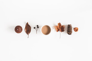 Autumn composition. Cup of coffee, autumn plants on white background. Flat lay, top view