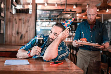 Left alone. Lonely mature man feeling extremely stressed and cheerless being left alone on birthday