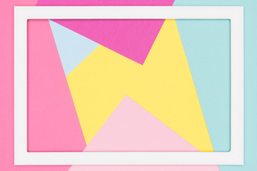 Abstract geometrical pastel blue, yellow and pink paper flat lay background. Minimalism, geometry template with empty picture frame mock up.