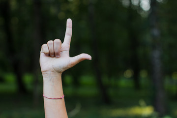 dactyl sign and symbols alphabet concept of human hand and fingers with letters on unfocused blurred dark bokeh natural background environment with empty space for copy or text