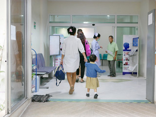 Asian mother taking her little baby to a hospital to see a doctor - baby's health care