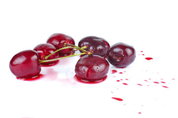 Crushed ripe cherries isolated on a white background