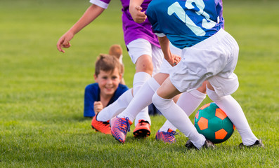 Young children players football match on soccer field