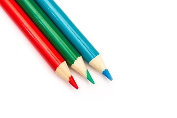Three colored pencils. The colors red, green and blue. The concept of polygraphy and digital RGB color transfer.