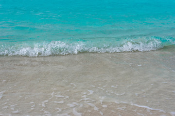 Waves breaking on a sandy beach in the Maldives Islands