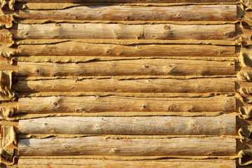 part of the wall made of wooden logs